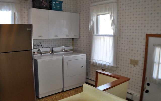 410 5th St, Montevideo, MN 56265 - laundry room with independent washer and dryer, wallpapered walls, cabinet space, and healthy amount of natural light