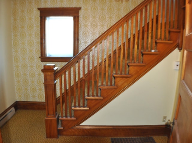 410 5th St, Montevideo, MN 56265 - staircase featuring wallpapered walls, a baseboard heating unit, and carpet floors