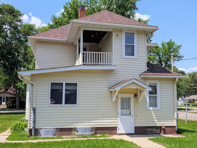 410 5th St, Montevideo, MN 56265 - view of front of property featuring a balcony, a chimney, and roof with shingles