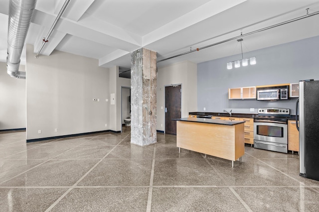 kitchen featuring stainless steel appliances, hanging light fixtures, and light brown cabinets