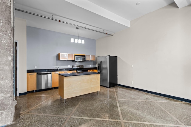 kitchen with stainless steel appliances, sink, decorative light fixtures, and a towering ceiling