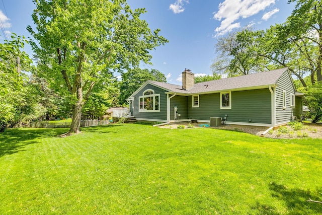 1755 Glenview Ave, Arden Hills, MN 55112 - back of house with central air condition unit, a chimney, and roof with shingles