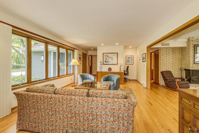1755 Glenview Ave, Arden Hills, MN 55112 - living room with light wood-type flooring, a brick fireplace, and recessed lighting