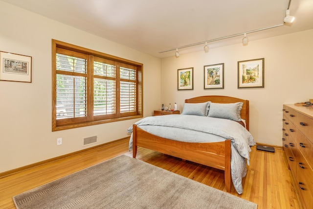 1755 Glenview Ave, Arden Hills, MN 55112 - bedroom featuring track lighting, light wood finished floors, and baseboards