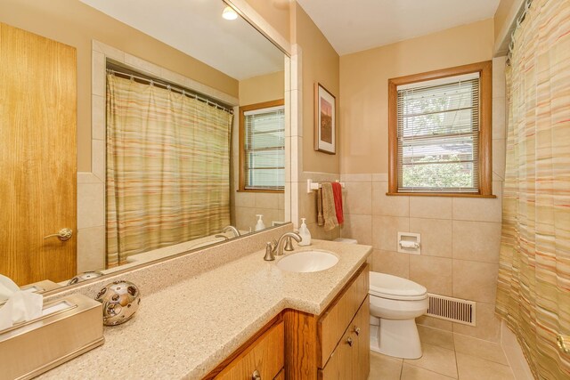 1755 Glenview Ave, Arden Hills, MN 55112 - full bathroom with tile patterned floors, toilet, tile walls, vanity, and a wainscoted wall