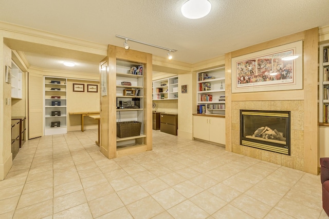 1755 Glenview Ave, Arden Hills, MN 55112 - living area with a textured ceiling, built in shelves, a fireplace, track lighting, and light tile patterned flooring