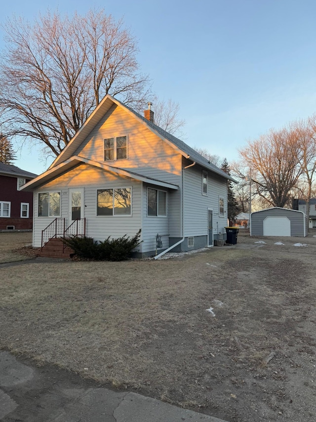 view of front facade featuring an outbuilding and a garage