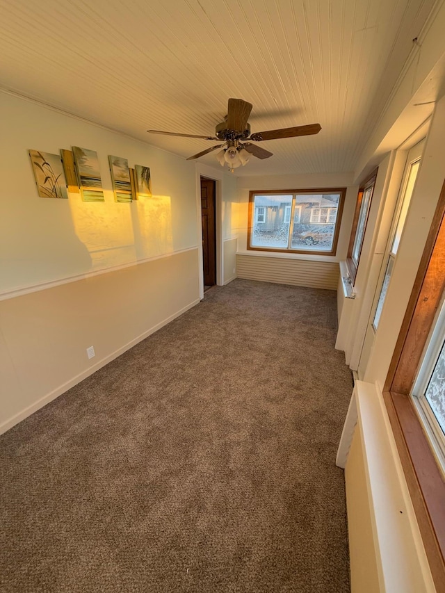 unfurnished room featuring dark carpet and ceiling fan