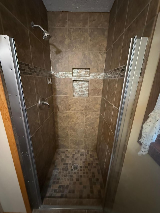 bathroom with a tile shower