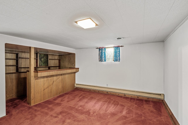 basement with dark colored carpet, baseboard heating, and wood walls