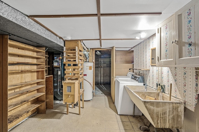 laundry room featuring sink, gas water heater, and washing machine and clothes dryer