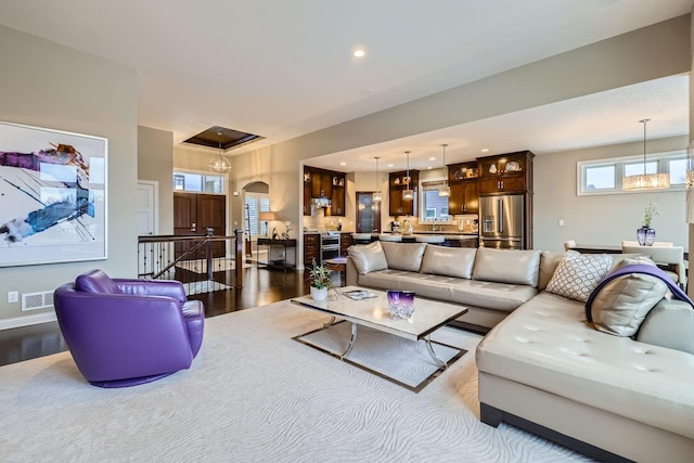 living room featuring an inviting chandelier and hardwood / wood-style floors