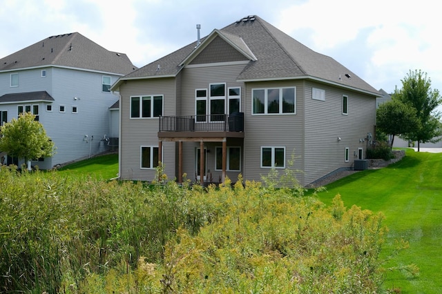 back of property featuring a yard and central AC