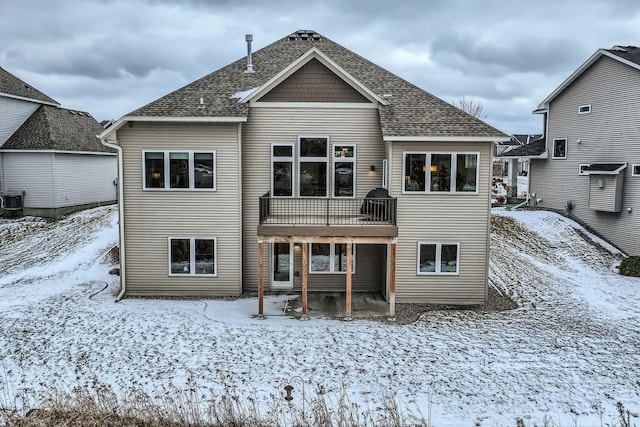 view of snow covered rear of property