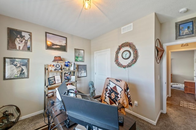 carpeted home office with a textured ceiling