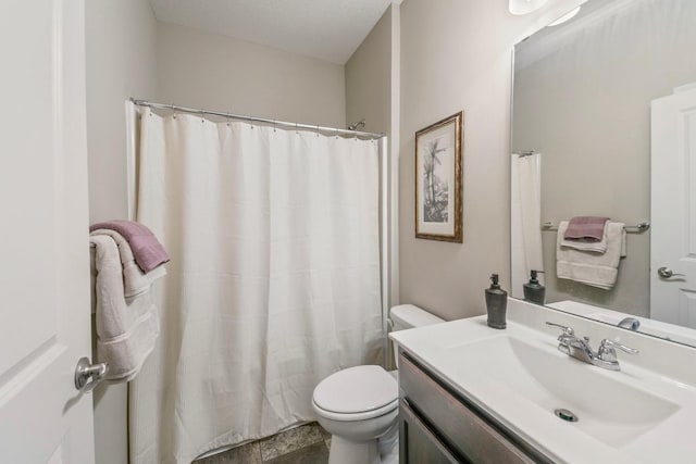 bathroom featuring walk in shower, vanity, and toilet