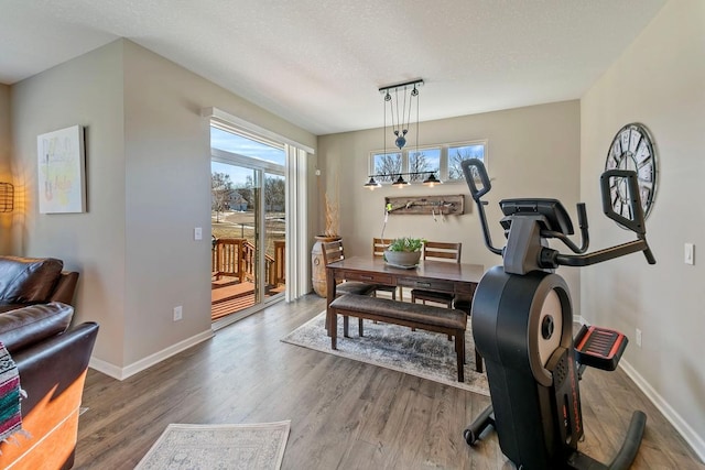 dining room with hardwood / wood-style flooring and a textured ceiling