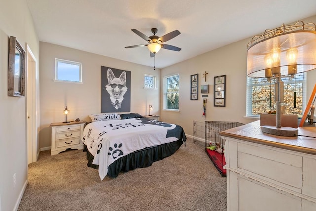 carpeted bedroom featuring multiple windows and ceiling fan