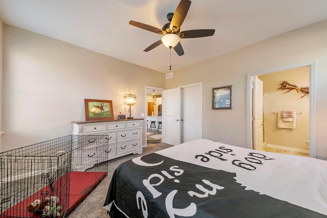 carpeted bedroom featuring ceiling fan, a closet, and ensuite bath