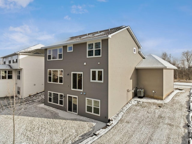 rear view of property with central AC unit