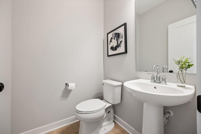 bathroom featuring toilet and hardwood / wood-style flooring