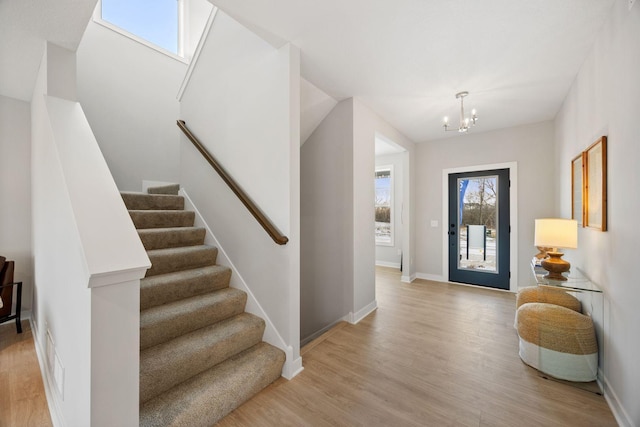 entrance foyer with a chandelier and light wood-type flooring