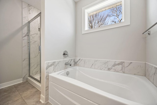 bathroom with separate shower and tub