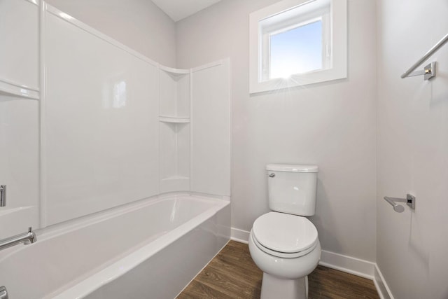 bathroom featuring shower / bathtub combination, toilet, and wood-type flooring