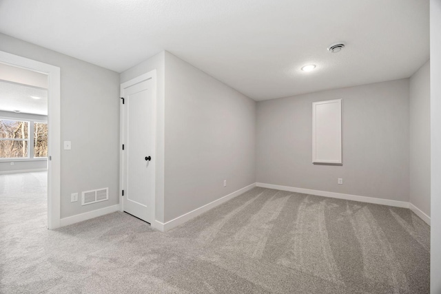 spare room featuring light colored carpet