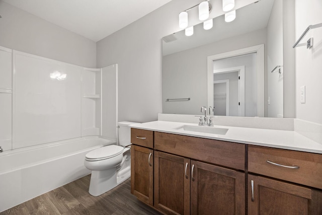 full bathroom with toilet, vanity, hardwood / wood-style floors, and bathtub / shower combination