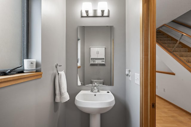 bathroom with hardwood / wood-style floors and toilet