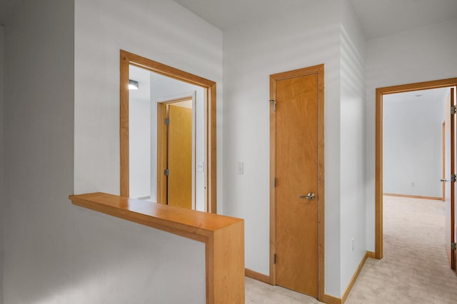 hallway with light colored carpet