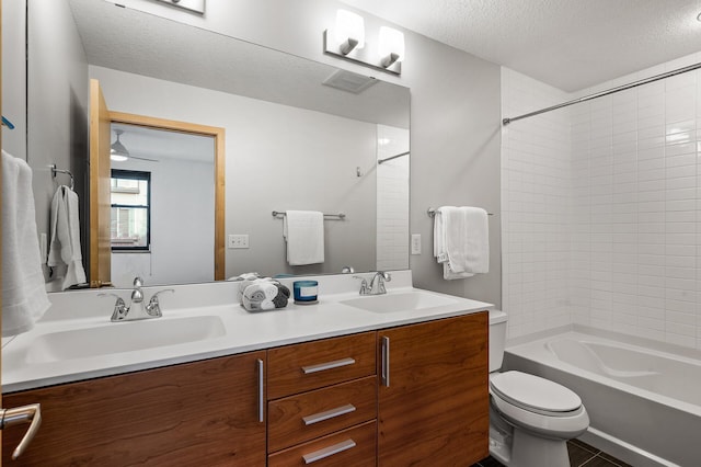 full bathroom with vanity, shower / tub combination, a textured ceiling, and toilet