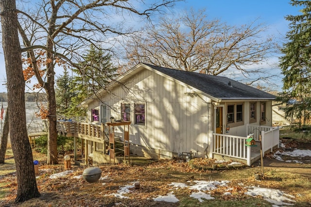 view of home's exterior featuring a deck with water view