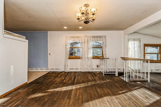 unfurnished dining area featuring hardwood / wood-style floors, an inviting chandelier, baseboard heating, and lofted ceiling