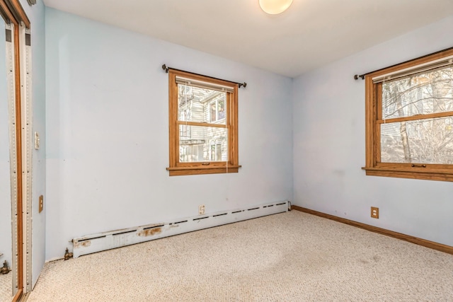 spare room with carpet flooring and baseboard heating