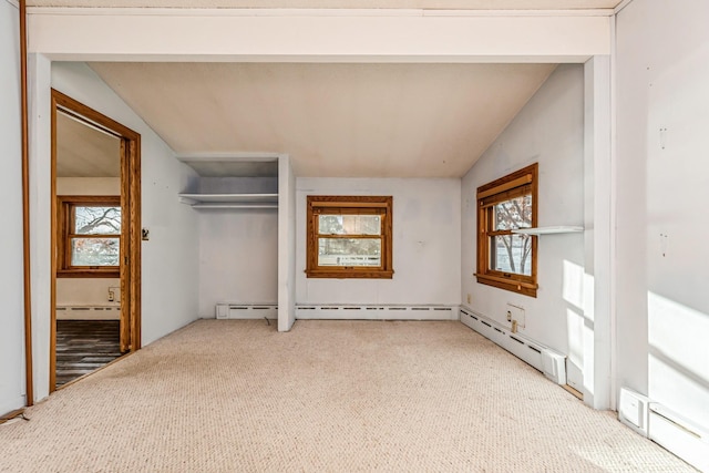 unfurnished bedroom with carpet, vaulted ceiling, and multiple windows