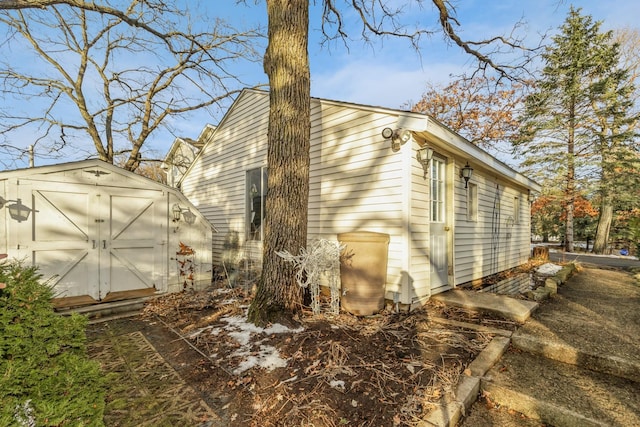 view of property exterior with a storage unit