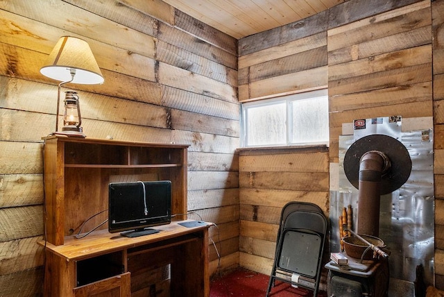 office featuring wood walls, wooden ceiling, and a wood stove