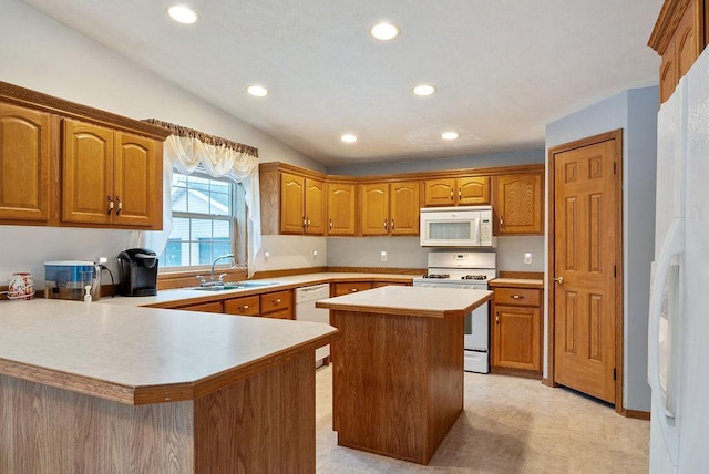 kitchen with kitchen peninsula, white appliances, sink, a kitchen island, and lofted ceiling