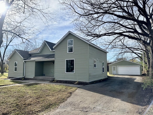 view of front of property with an outdoor structure and a garage