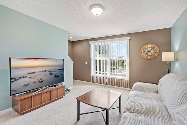 living room with light colored carpet and a textured ceiling