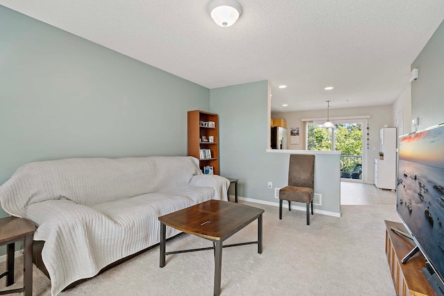 living room with a textured ceiling and light colored carpet