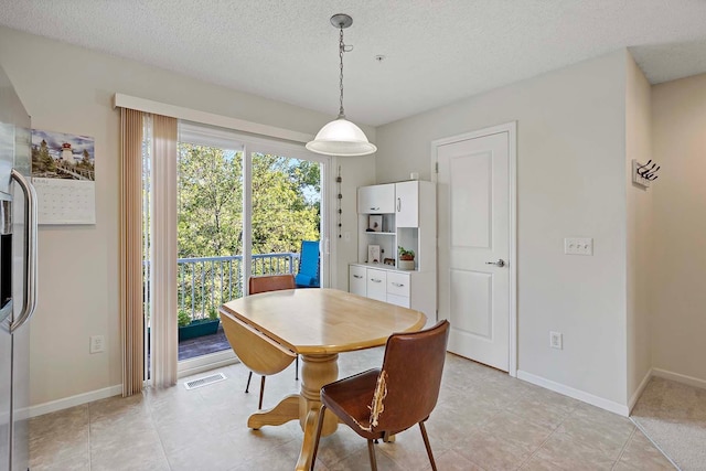 dining space with a textured ceiling