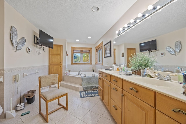 3078 70th St SW, Waverly, MN 55390 - bathroom featuring tile patterned flooring, vanity, a garden tub, a textured ceiling, and tile walls
