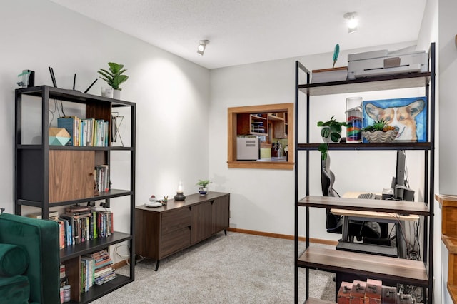 misc room with a textured ceiling, light colored carpet, and a wall unit AC