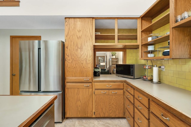 kitchen featuring appliances with stainless steel finishes and backsplash