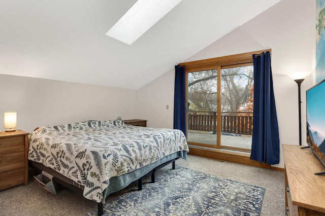 carpeted bedroom with access to exterior and lofted ceiling with skylight