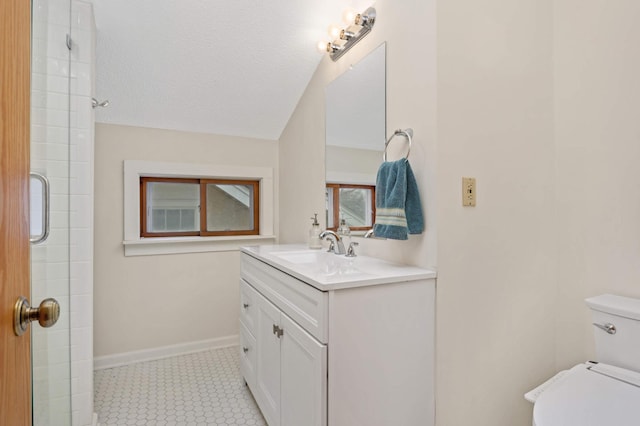 bathroom featuring a textured ceiling, vanity, toilet, and a shower with shower door