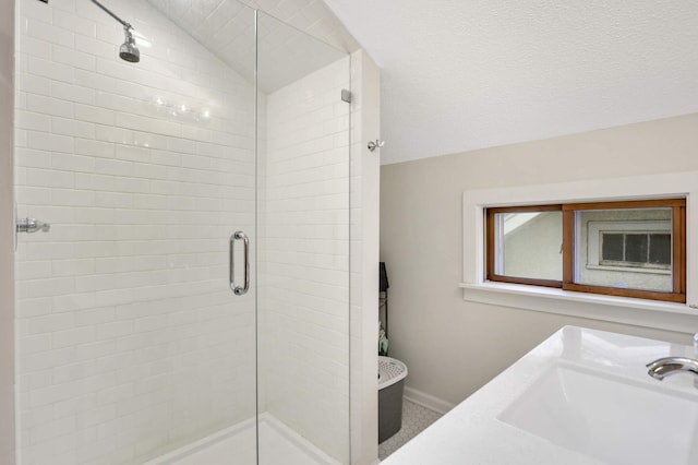 bathroom with vaulted ceiling, sink, and walk in shower